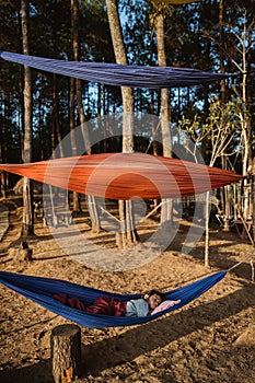 Asian kid relaxing on hammock outdoor