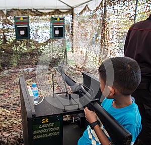 Asian kid shoot simulator machine gun