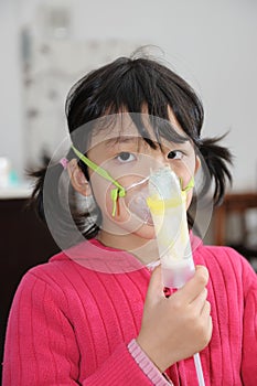 Asian kid taking respiratory
