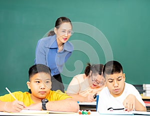 Asian kids with disability in special school classroom with Autism child and beautiful Asian female  teacher