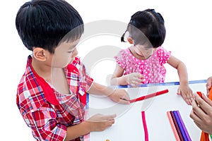 Asian kids playing with play clay on table. Strengthen the imagi