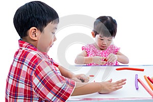 Asian kids playing with play clay on table. Strengthen the imagi