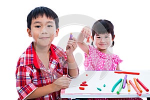 Asian kids playing with play clay on table. Strengthen the imagination