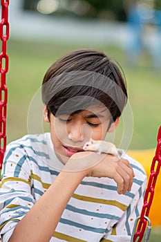 Asian Kids playing at playground outdoor with happy smile with hamster