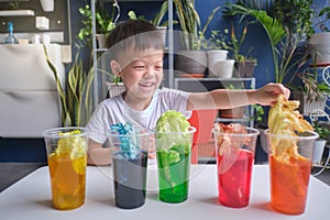 Asian kindergarten boy having fun making Rainbow Cabbage Experiment, Kid learn about how plants thrive by pulling water through