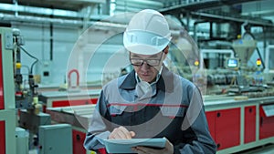 Asian, Korean chinese professional male engineer in hard hat using digital tablet