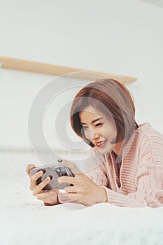 Asian Korean female playing online games on mobile phone