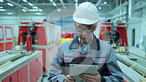 Asian, Korean professional engineer man in hard hat using tablet indoors