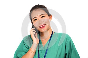 Asian Korean woman as successful physician talking on hand phone - young beautiful and happy medicine doctor or hospital nurse in