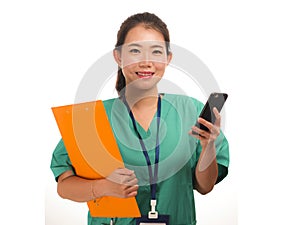 Asian Korean woman as successful physician using hand phone - young beautiful and happy medicine doctor or chief hospital nurse in