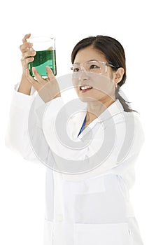 Asian laboratory technician studying a beaker of liquid