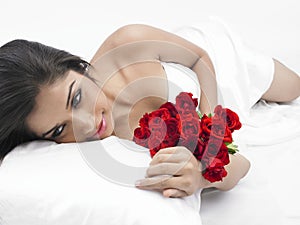 Asian lady in bed with roses