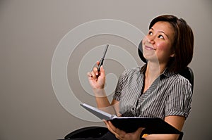 Asian lady in business attire, getting an idea photo