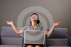 Asian lady in business attire, using a computer photo