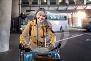 Asian lady carry travel bag in international airport