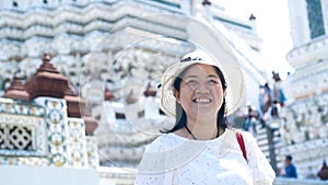 Asian lady enjoying for traveling at Wat Arun. Bangkok. Thailand. Slow Motion