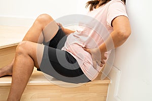 Asian lady fall down the stairs and pain at hip and waist because slippery surfaces