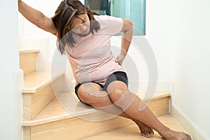 Asian lady fall down the stairs and pain at hip and waist because slippery surfaces