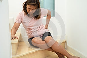 Asian lady fall down the stairs and pain at hip and waist because slippery surfaces