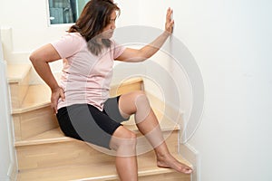 Asian lady fall down the stairs and pain at hip and waist because slippery surfaces