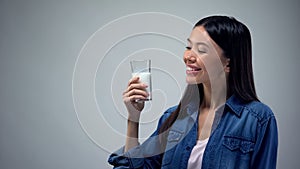 Asian lady holding milk glass, source of calcium and energy, bifid product