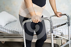 Asian lady patient wearing back pain support belt for orthopedic lumbar.