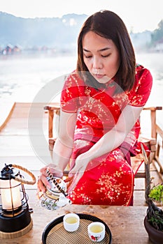 Asian lady portrait relax in Chinese style long dress or vietnam contemporary accessories happy on location morning