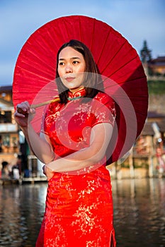 Asian lady portrait relax in Chinese style long dress or vietnam contemporary accessories happy on location morning