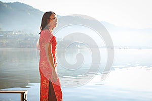 Asian lady portrait relax in Chinese style long dress or vietnam contemporary accessories happy on location morning