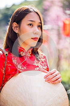 Asian lady portrait relax in Chinese style long dress or vietnam contemporary accessories happy on location morning