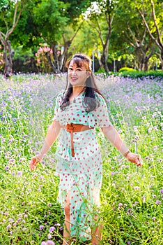 Asian lady in the purple lavender flower bush under sunset