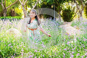 Asian lady in the purple lavender flower bush under sunset