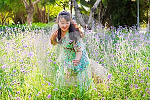 Asian lady in the purple lavender flower bush under sunset