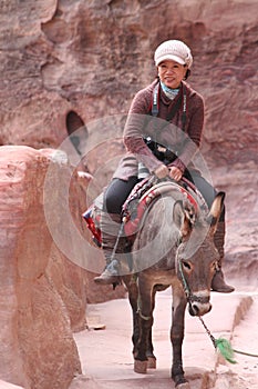 Asian lady riding donkey in Petra Jordan