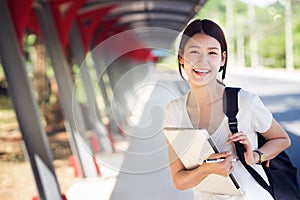 Asian lady student in university walking in walk way