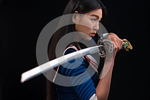 Asian lady with sword in studio