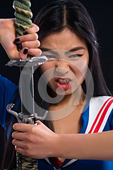 Asian lady with sword in studio