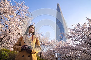 Asian lady travel and warking in cherry blossom park