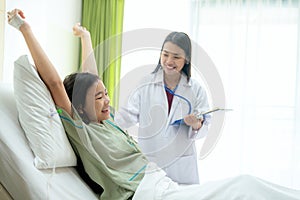 Asian lady very happy with her doctor after health check