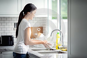 Asian lady wash a dish