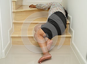 Asian lady woman injury from falling down on slippery surfaces stairs at home