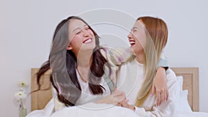 Asian LGBT couple singing and dancing in bedroom together. Lesbian women happy in romance, love and fun time in the living room.