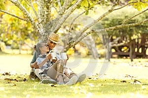 Asian Lifestyle senior couple drinking coffee  in the nature park