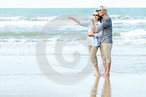 Asian Lifestyle senior couple hug on the beach happy in love romantic and relax time