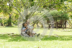 Asian Lifestyle senior elderly retire couple drinking coffee in the nature park happy and relax time.  Elderly family the rest and