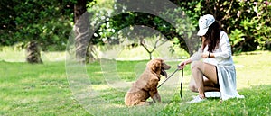 Asian lifestyle woman playing with dog golden retriever friendship so happy and relax outdoor the summer park