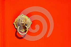 Asian Lion Door Knocker on Red Background