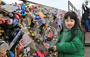 Asian littel girl pictures with the keys locked, love padlocks and keys wish love forever at N Seoul Tower,South Korea
