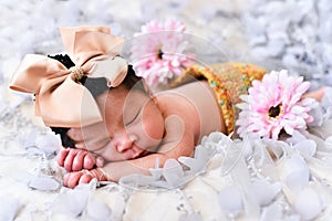 Asian little baby newborn girl sleeping on a lace with flower pattern