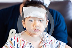 Asian little baby sick with cool fever jel pad on forehead
